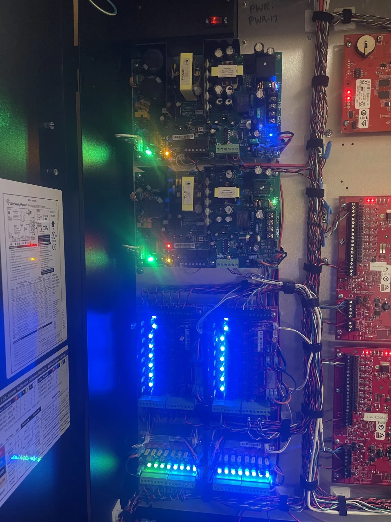 Power supplies and distribution boards inside an access control cabinet.