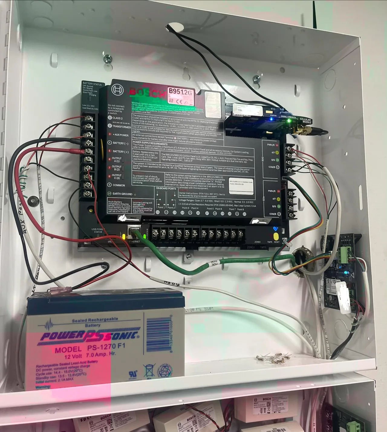 Bosch B9512G control panel with communications hardware and backup battery.