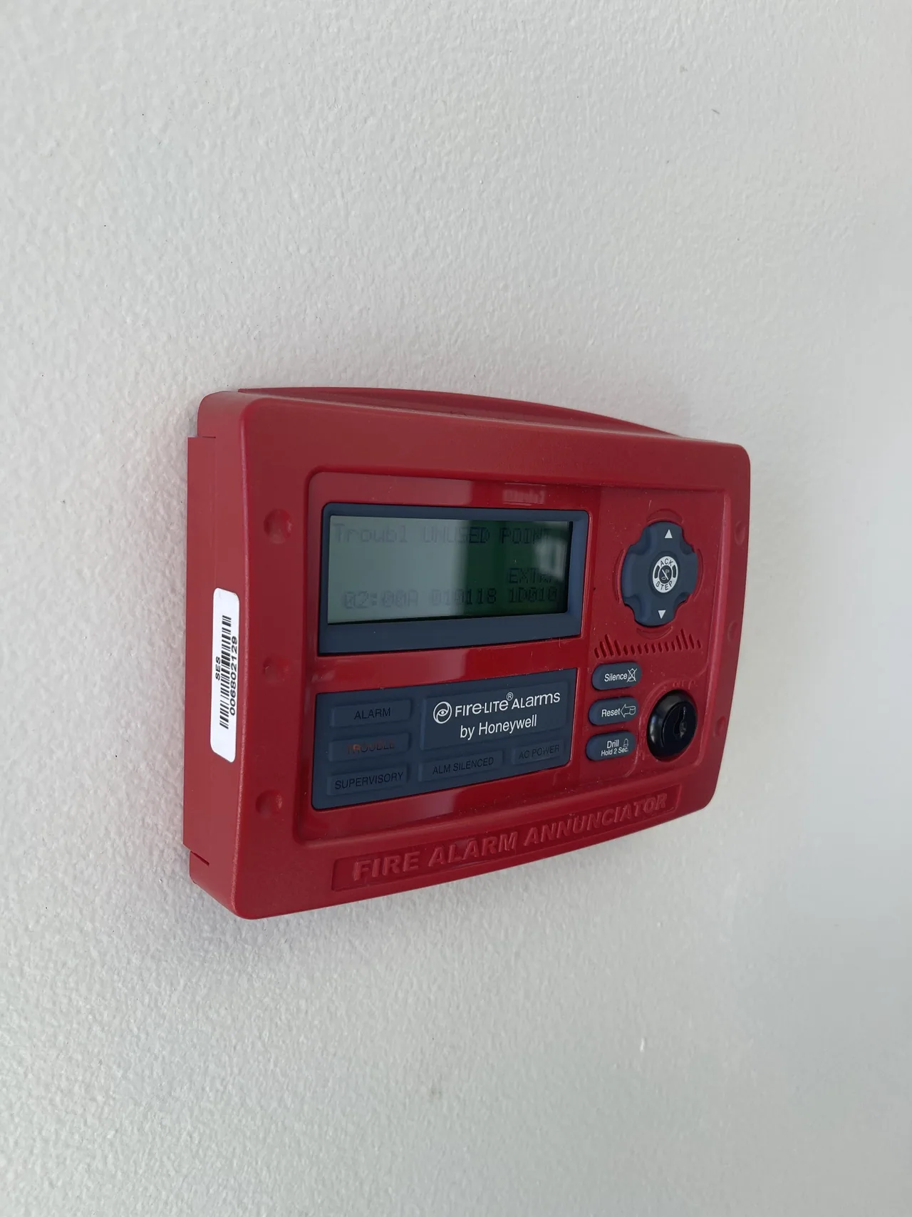 Red wall-mounted Fire-Lite fire alarm annunciator.