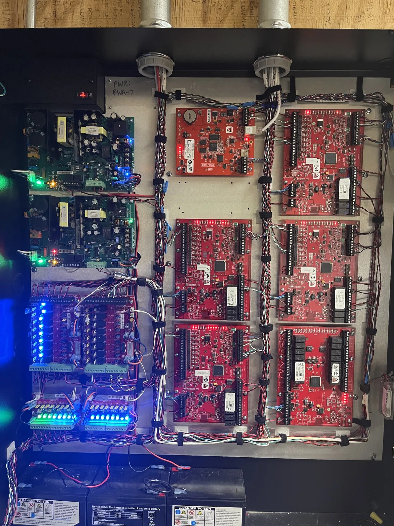 Open access control enclosure with Lenel interface boards, power supplies and organized wiring.