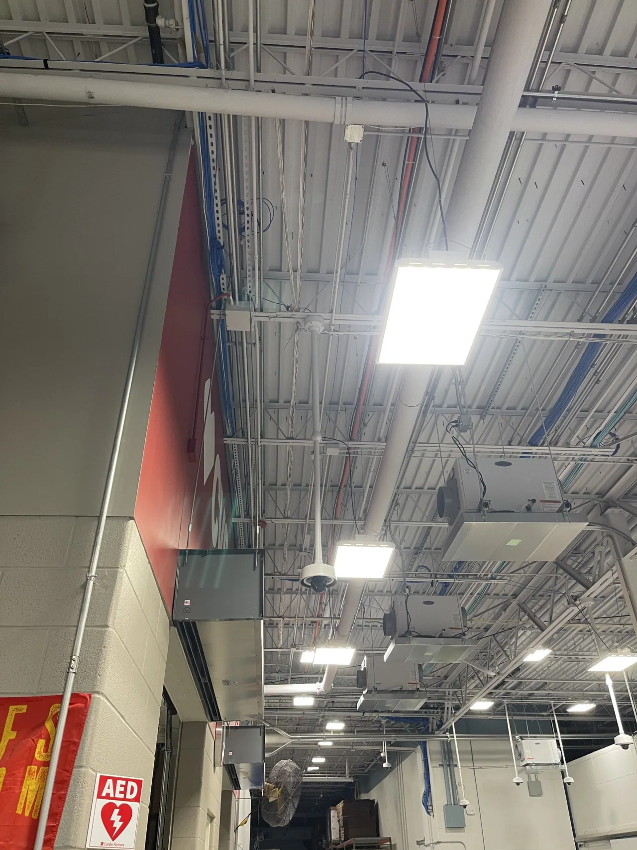 Commercial surveillance cameras suspended below an exposed structural ceiling.